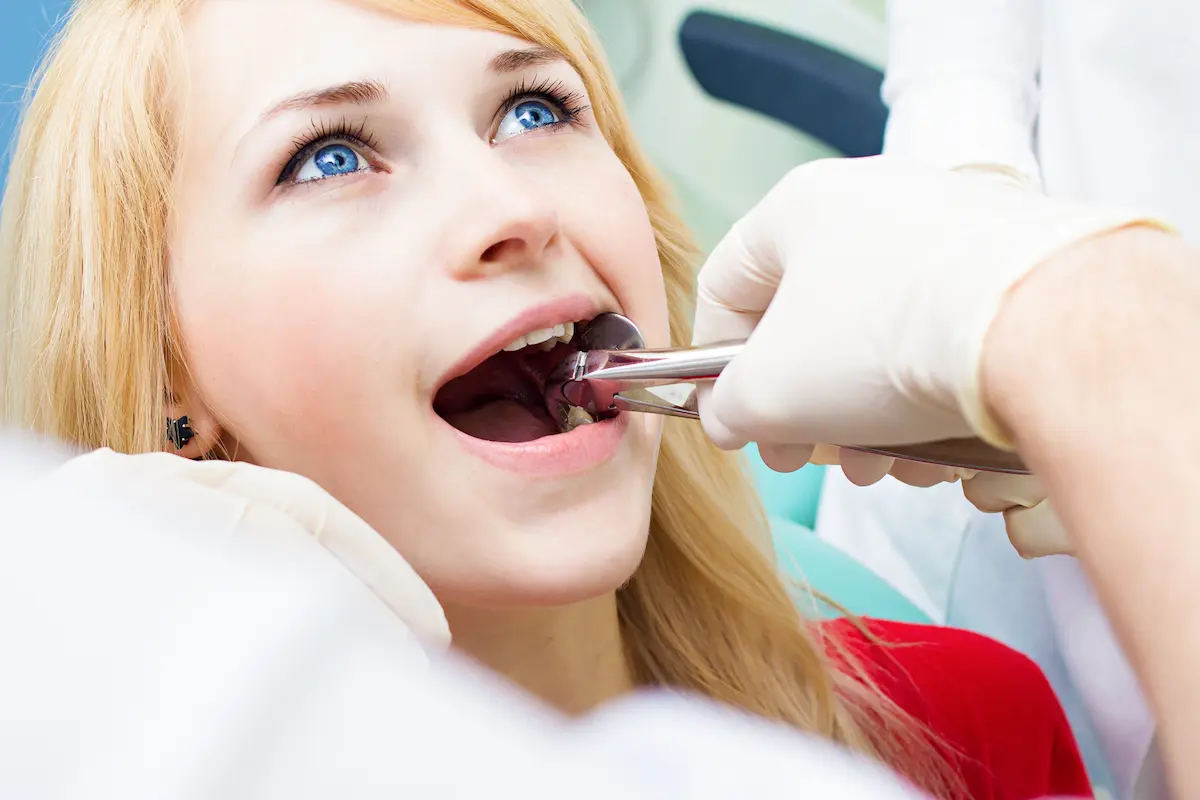 woman having tooth extractions in Greenville SC