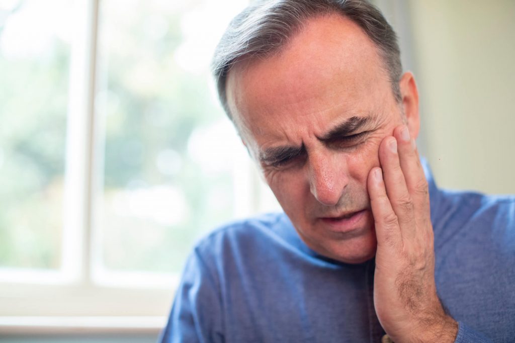 Man with pain emergency dentist Greenville SC