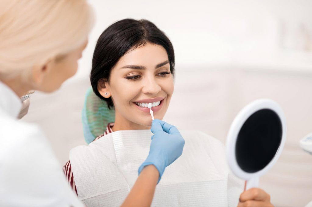 dentist in simpsonville SC putting veneers on a patient